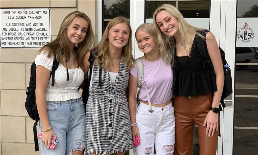 A group of students smiles